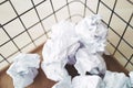 Trash basket and paper crumples. Overflowing waste paper in office. Royalty Free Stock Photo