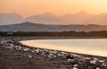 Trash beach of the big city. Empty used dirty plastic bottles. Dirty sea sandy coast of the Red Sea. Ecological problem. Royalty Free Stock Photo