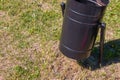 Trash bin and cigarette butts in the grass Royalty Free Stock Photo