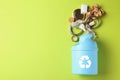 Trash bin and different garbage on color background, top view with space for text. Royalty Free Stock Photo