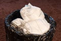 A trash bin full of dirty used baby`s diapers. Disposable nappies