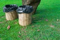 Trash bin made of bamboo baskets on green grass Royalty Free Stock Photo