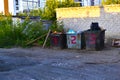 Trash bins under numbers in the city around the corner