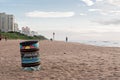 Trash can on the beach near fisherman in Umhlanga Rocks