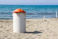 Trash can on the beach sunny day. Concept photo of a clean beach Royalty Free Stock Photo