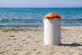 Trash can on the beach sunny day. Concept photo of a clean beach Royalty Free Stock Photo