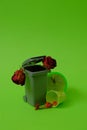 Trash can, dead flowers, green bucket and a clock showing 5 minutes before 12 on a green background. Text space. Environmental Royalty Free Stock Photo