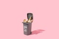 Trash can full of seshells on a pastel pink background. Minimal summer marine life nature concept. Sustainable environment idea