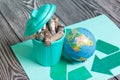 A trash can with a lid filled with waste batteries stands on the waste recycling sign. The batteries are covered with corrosion.