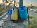 Trash can in the park where the supporting legs have been broken Royalty Free Stock Photo