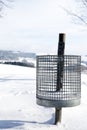 Trash can in the snow, concept winter tourism
