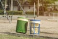 Trash cans in a playground park area with recycling and proper cleanliness