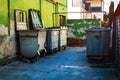 Trash container dumpsters in dirty alley Royalty Free Stock Photo