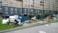 Trash container and garbage near apartment residential building in the city. Problem of cleaning, cleanliness and environmental