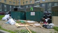 Trash container and garbage near apartment residential building. Problem of cleaning, cleanliness. Messy. Real city life.