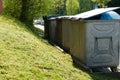 Trash containers for different types of household waste. The normal house waste can only be disposed in blue plastic bags for this Royalty Free Stock Photo