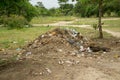 Trash and debris piled at an entrance to a park