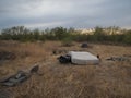 Trash dumped in the desert at sunset