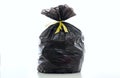 Trash, black garbage bag full and tied isolated against white background Royalty Free Stock Photo