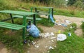 Trash and garbage near bench in mountain forest landscape