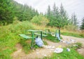 Trash and garbage near bench in mountain forest landscape