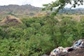 Trash garbage piles thrown along mountain side by uncaring and irresponsible neighborhood Royalty Free Stock Photo