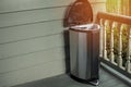 Trash on home porch. Smelly garbage bin outside for removal fro