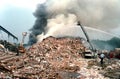 Trash landfill fire wth fire trucks using ladder pipes and water fighting it