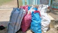 trash packed in large sacks and ready to be transported by garbage trucks