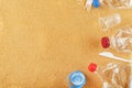 Plastic trash on a sandy beach with Trash from plastic bottles on a sandy beach with free space. Royalty Free Stock Photo