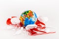 Trash scattered around globe on white Royalty Free Stock Photo