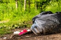 Trash thrown in the forest. Problems of environmental protection and plastic recycling. Selective focus Royalty Free Stock Photo
