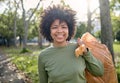 Trash, volunteer portrait and black woman cleaning garbage pollution, waste product or environment support. Plastic bag