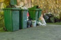 Trash waiting for collection in back alley under dim light in th