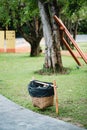Trashcan bin bamboo basket in the park. Royalty Free Stock Photo
