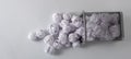 A trashcan full of crumpled paper on white background close up