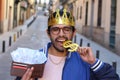 Trashy man biting the dollar sign Royalty Free Stock Photo