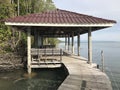 Sea view pavilion and wooden bridge walkway along the sea of `Mature mangrove forest and black sand beach` in Trat, Thailand.