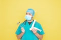 Trauma surgeon wearing an operating theatre uniform and stethoscope, checking a skeleton model of a foot, right lower limb, all on