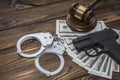 Traumatic gun, money, hammer of the judge. Royalty Free Stock Photo