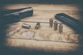 Traumatic pistol with bullets and cartridge on the wooden surface, vintage effect Royalty Free Stock Photo