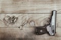 Traumatic pistol with bullets and cartridge on the wooden surface, vintage effect Royalty Free Stock Photo