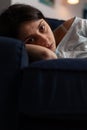 Traumatised depressed woman crying lying on sofa Royalty Free Stock Photo