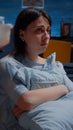 Traumatised woman with black stares sitting alone on floor Royalty Free Stock Photo