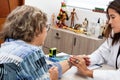 Traumatologist female doctor at her office examining a senior female patient. Skeleton bone disease exam and medic aid. Career Royalty Free Stock Photo