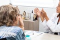 Traumatologist female doctor at her office examining a senior female patient. Skeleton bone disease exam and medic aid. Career Royalty Free Stock Photo