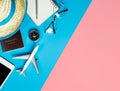 Travel objects and gadgets top view flatlay on blue yellow pink Royalty Free Stock Photo