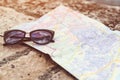 Travel accessories on stone bench background. Traveller map and sunglasses. Traveler items vacation. Happy weekend day. Travelling Royalty Free Stock Photo