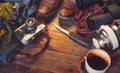Travel Accessories On Wooden Background. Old hiking leather boots, backpack, vintage film camera, knife and thermos