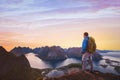 Hiker with backpack enjoying sunset landscape in Lofoten, Norway